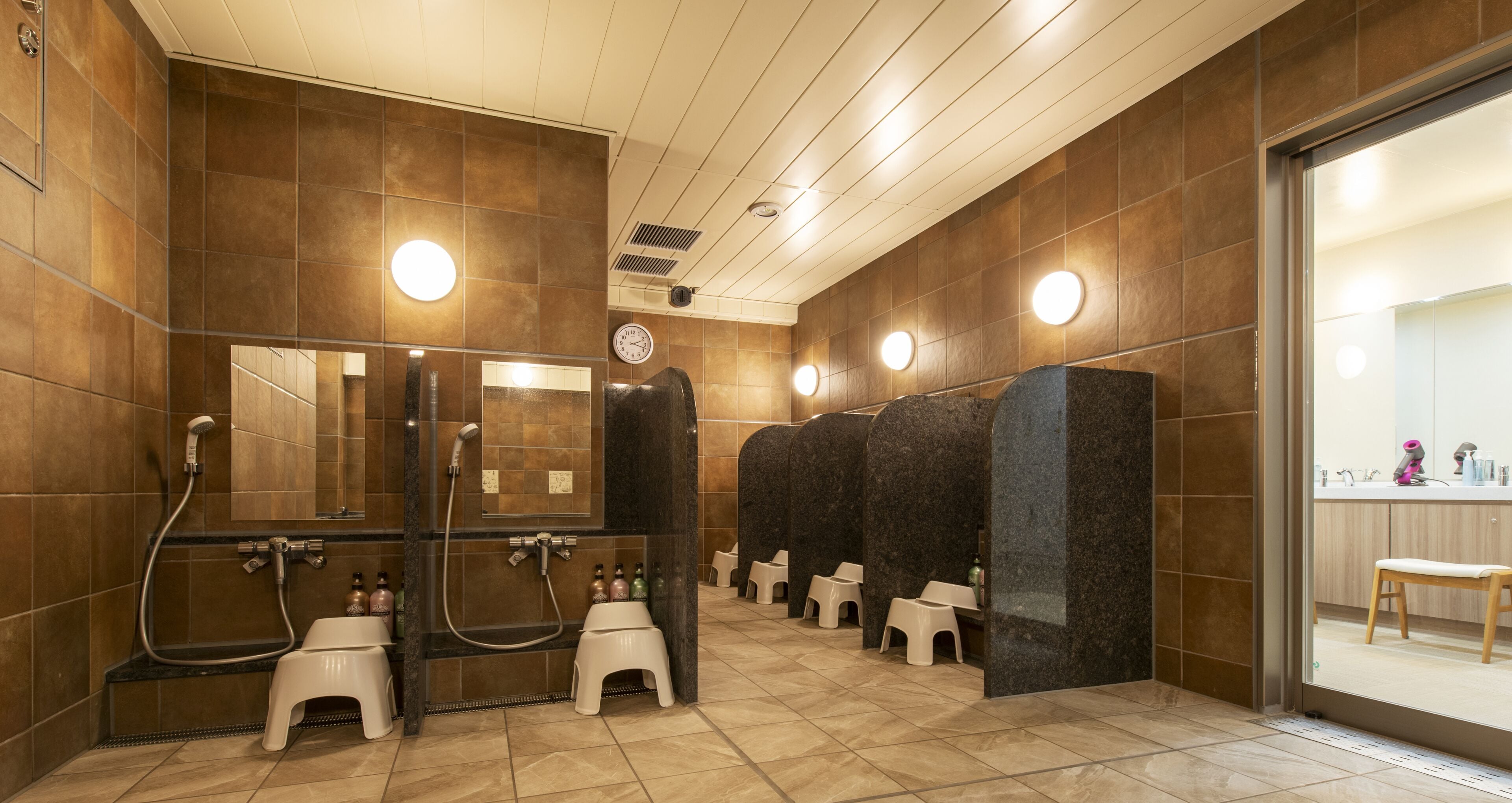 A modern bathroom with a shower, toilet, and sink area.