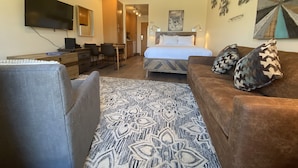 A hotel room with a bed, a desk, a TV, and a couch. - Balcony with Views | Hot Tub & Firepit Enjoyment (Keystone)