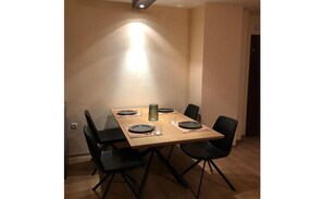Enjoy meals in this dining area with a table for four and modern chairs.