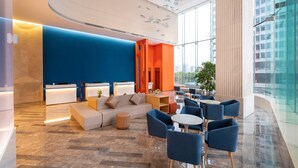 A modern lobby with a reception desk, seating area, and large windows offering views of the city. - Holiday Inn Express Chengdu High-Tech Zone by IHG (Chengdu)