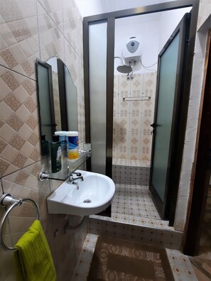 Shower, towels, soap, toilet paper