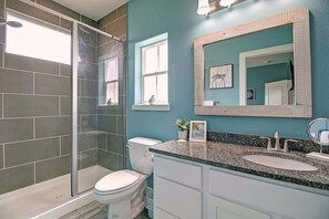 Bathtub, hair dryer, towels, shampoo