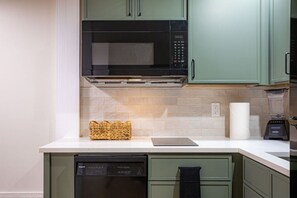 Fridge, microwave, coffee/tea maker, cookware/dishes/utensils