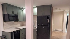 A kitchen with a microwave, refrigerator, and dishwasher. - Fresh Walkable Fremont Home Near Ballard/Downtown (Seattle)