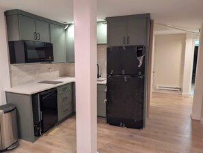 A kitchen with a microwave, refrigerator, and dishwasher. - Fresh Walkable Fremont Home Near Ballard/Downtown (Seattle)