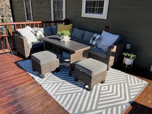 A patio with wicker furniture, a table, and a patterned rug. - LOCATION LOCATION LOCATION! (Blue Ridge)