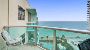 A balcony with a view of the ocean and a pool area. - Beach Penthouse & Ocean Paradise (Hollywood)
