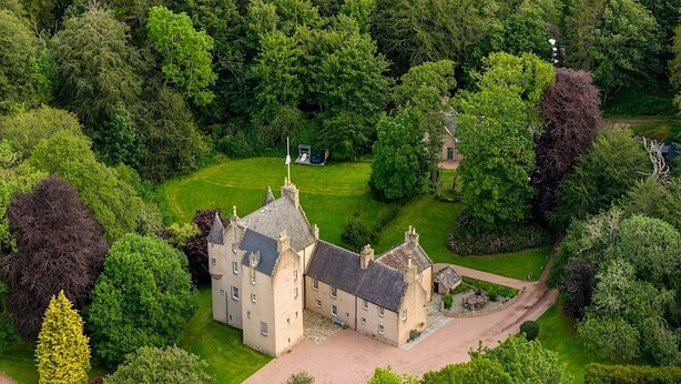 An aerial view of a large, historic building surrounded by lush greenery. - Historic Fairytale Lickleyhead Castle (Insch)