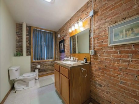Combined shower/bathtub, hair dryer, towels, soap. 30 West · The Den ·Downtown Hideaway near Fairground