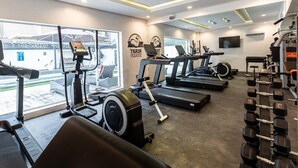 A gym with treadmills, elliptical machines, and dumbbells. - Zen Apartments (Lagos)