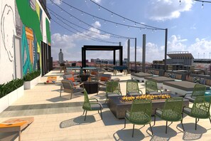 An outdoor seating area with chairs, tables, and a fire pit. - Hilton Grand Vacations Club La Pacifica Los Cabos (San José del Cabo)