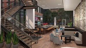 A modern interior with a staircase, seating area, bar, and large windows. - Hilton Grand Vacations Club La Pacifica Los Cabos (San José del Cabo)