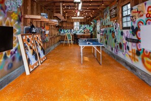 Relax and play in this vibrant space with a ping pong table and lively graffiti art.