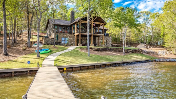 A lakeside lodge with a dock, stone exterior, and a covered porch. - Killen Time on Lake Martin (Dadeville)