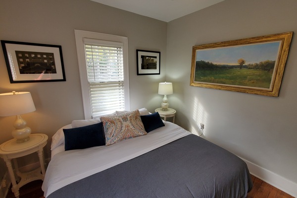 Primary bedroom features a king bed with a ceiling fan