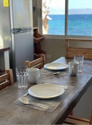Enjoy a romantic meal for two with a view of the ocean and mountains from this dining area.