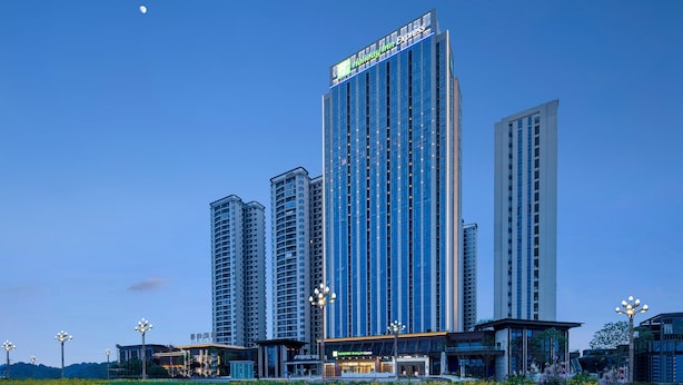 A high-rise Holiday Inn Express hotel with a modern glass facade, multiple floors, and a prominent sign at the top. - Holiday Inn Express Chengdu Tianfu Airport Zone by IHG (Chengdu)