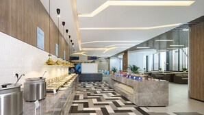 A modern hotel lobby with a long buffet line, a seating area, and a reception desk. - Holiday Inn Express Chengdu Tianfu Airport Zone by IHG (Chengdu)