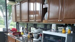 A kitchen with wooden cabinets, a microwave, a stove, and various kitchen items. - RV Executive Home #4, Indoor - Inground Pool ..Jacuzzi heated by request (Cottondale)