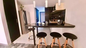 Fridge, microwave, coffee/tea maker, cookware/dishes/utensils