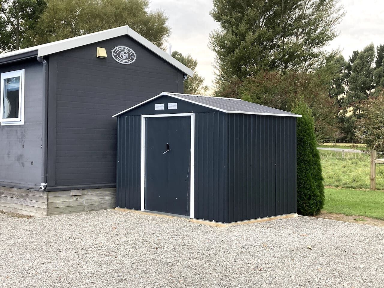 A building with a dark exterior, a door, and a window.