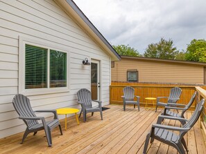 Relax on the deck with Adirondack chairs and a small table, perfect for outdoor dining or unwinding.