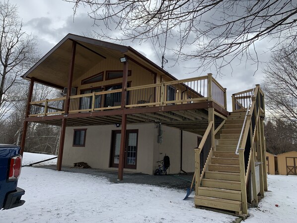 Enjoy a cozy retreat with a balcony overlooking the surrounding trees.