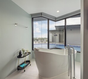 Deluxe Pool Access with Bathtub | Bathroom | Shower, hydromassage showerhead, hair dryer, bathrobes