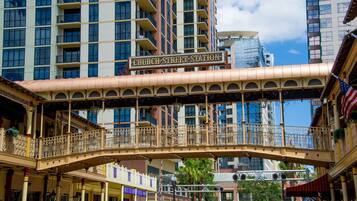 A covered pedestrian bridge with ornate railings and a sign reading "Church Street Station".