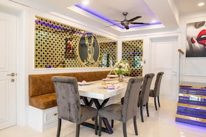 Enjoy dining in style with a beautifully set table and elegant artwork.