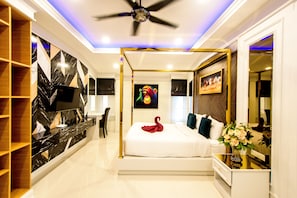 Relax in a serene space with a large bed, flat-screen TV, and a stylish bedside table.