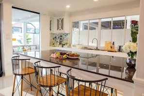 Enjoy meals and socializing around the central island in this modern kitchen.