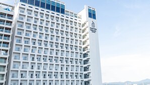 A modern hotel building with a prominent 'Parkview Terrace' sign, featuring a grid of balconies and a clear sky in the background. - Parkview Terrace Hotel (Paju)