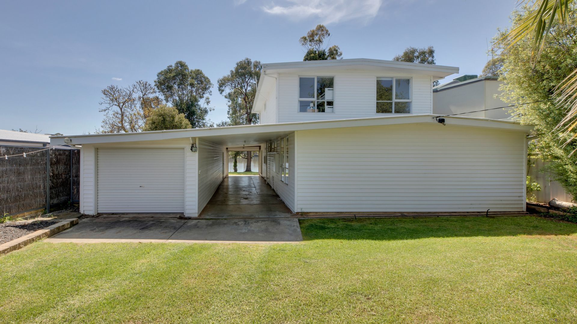 A two-story house with a garage and a covered driveway.