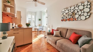 A modern living room with a sofa, a dining area, and a kitchen. - Co-ownership (Nice)