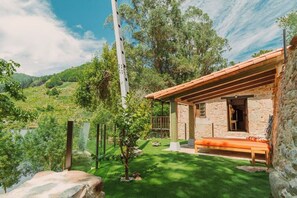 Escape to a serene valley setting, surrounded by rolling hills and lush trees.