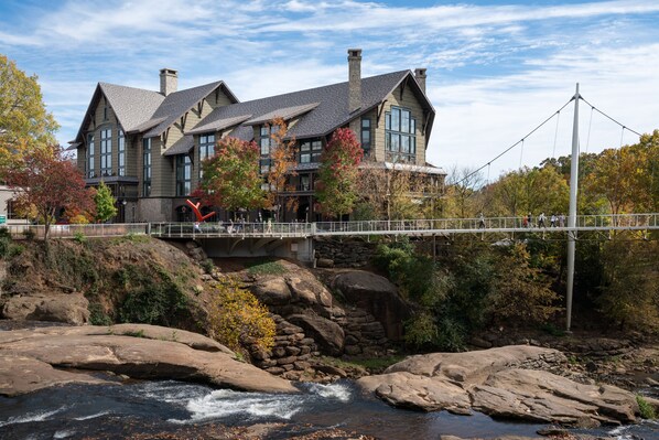 Un edificio de piedra grande con un puente sobre un río.