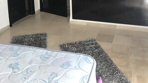 A bedroom with a bed, a large wardrobe, and a door leading to another room. - Superb Mont Carlo Hamam Sousse vacation apartment (Hammam Sousse)