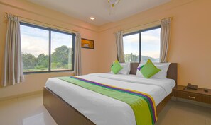 Desk, laptop workspace, iron/ironing board, bed sheets