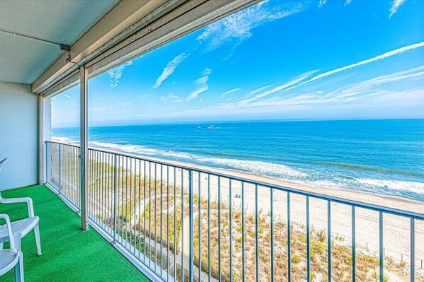 Enjoy the ocean view from this balcony with a clear view of the sea and surrounding boats.