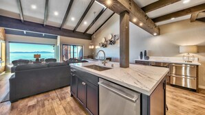 A modern kitchen with a large island, stainless steel appliances, and a view of the sea. - Stunning Lakefront Near Heavenly LLV611 (South Lake Tahoe)