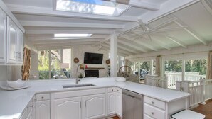 A spacious kitchen with white cabinetry, a built-in dishwasher, and a large island. - "Driftwood" in S. Forest Beach! (Hilton Head Island)