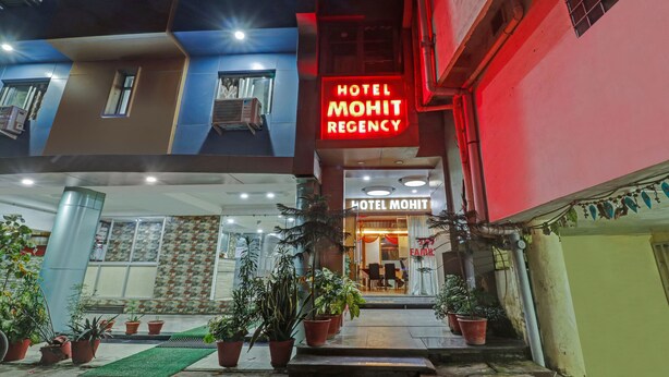 The exterior of Hotel Mohit Regency with a prominent neon sign, a tiled entrance, and potted plants. - Treebo Mohit Regency (Bhopal)