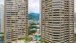 A high-rise building with a rooftop pool and lounge area. - 2-Bedroom Ocean View, Perfect Location In Wakiki (Honolulu)