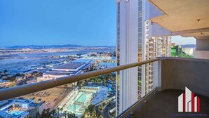 A high-rise building with a balcony overlooking a cityscape. - MGM Signature-28-714 1BR 2-Bath Balcony Suite (Las Vegas)