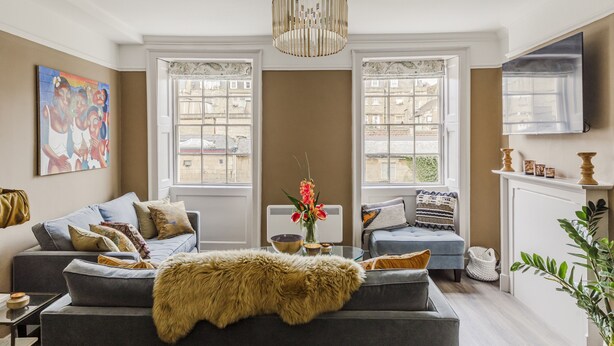 A living room with a sofa, a coffee table, and a fireplace. - Impeccable 4-bed Apartment in Bath (Bath)