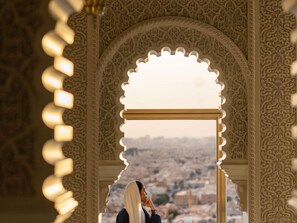 An ornate archway with intricate patterns and a view of a cityscape.