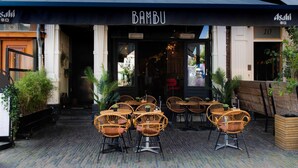 A restaurant named "Bambu" with outdoor seating and a brick-paved entrance. - Bambu Sleep Boutique double room 4 (Haarlem)