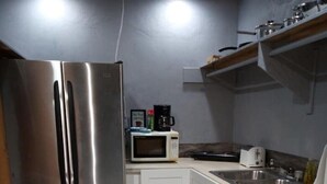A compact kitchen with stainless steel appliances, a microwave, and a toaster. - Island hide away 1 (Freeport)