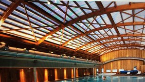 An indoor swimming pool with a high ceiling and wooden paneling. - AT THE FOOT OF THE CHAMPAGNY EN VANOISE SLOPES LA PLAGNE-PARADISKI PARC DE LA VANOISE (Champagny-en-Vanoise)